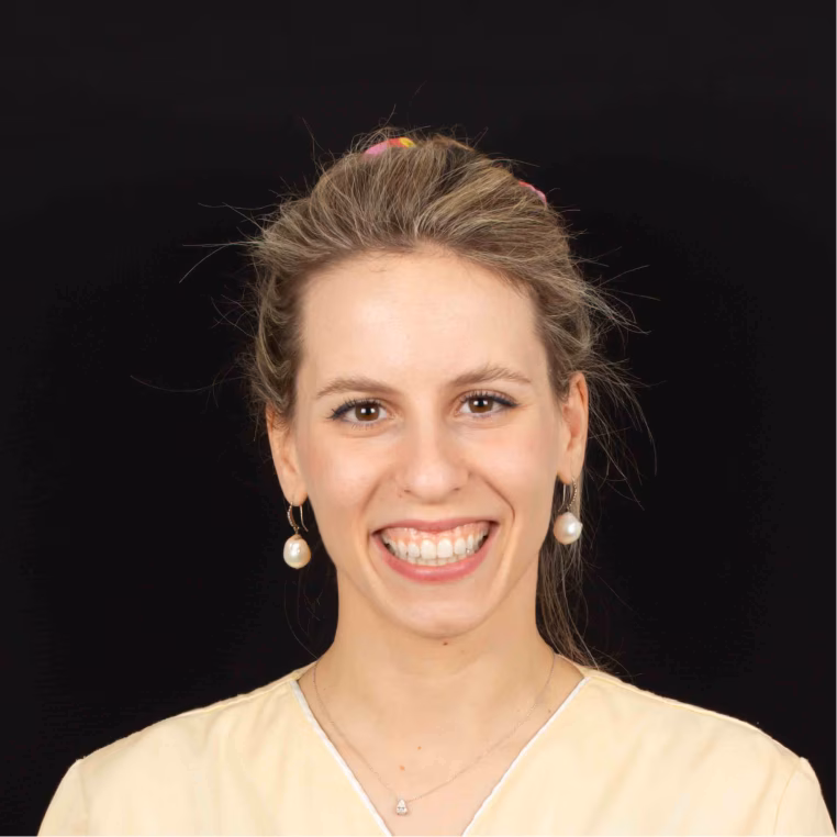 Smiling female dentist in a white coat