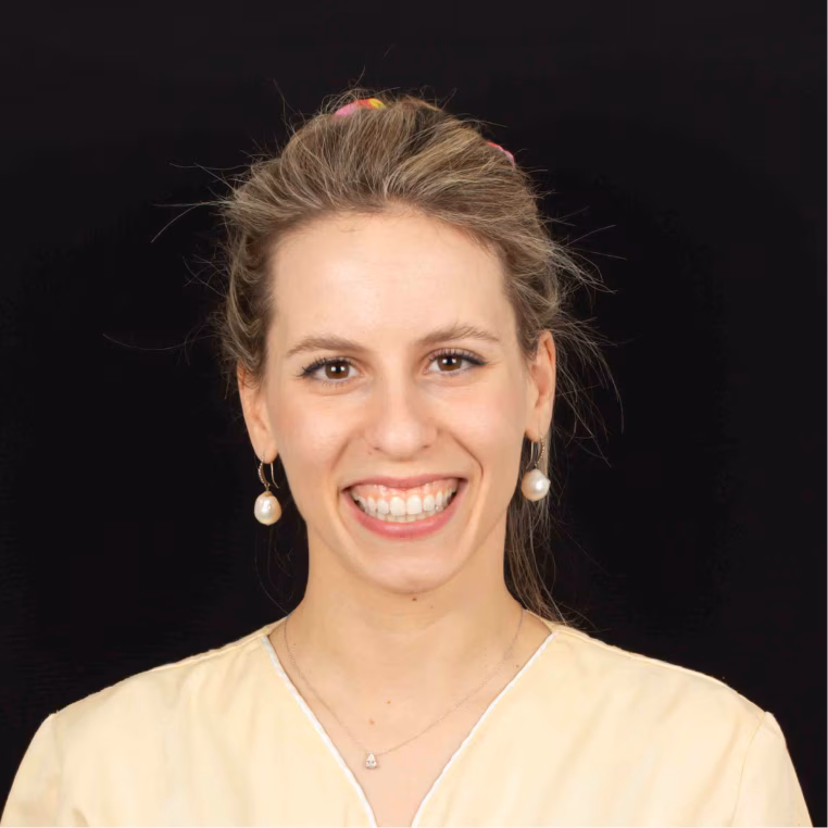 Dr. Name2, smiling dentist in a white coat