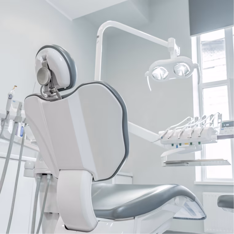 Dental treatment chair with overhead exam light