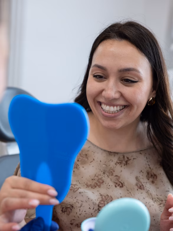 Smiling female patient in a dental chair